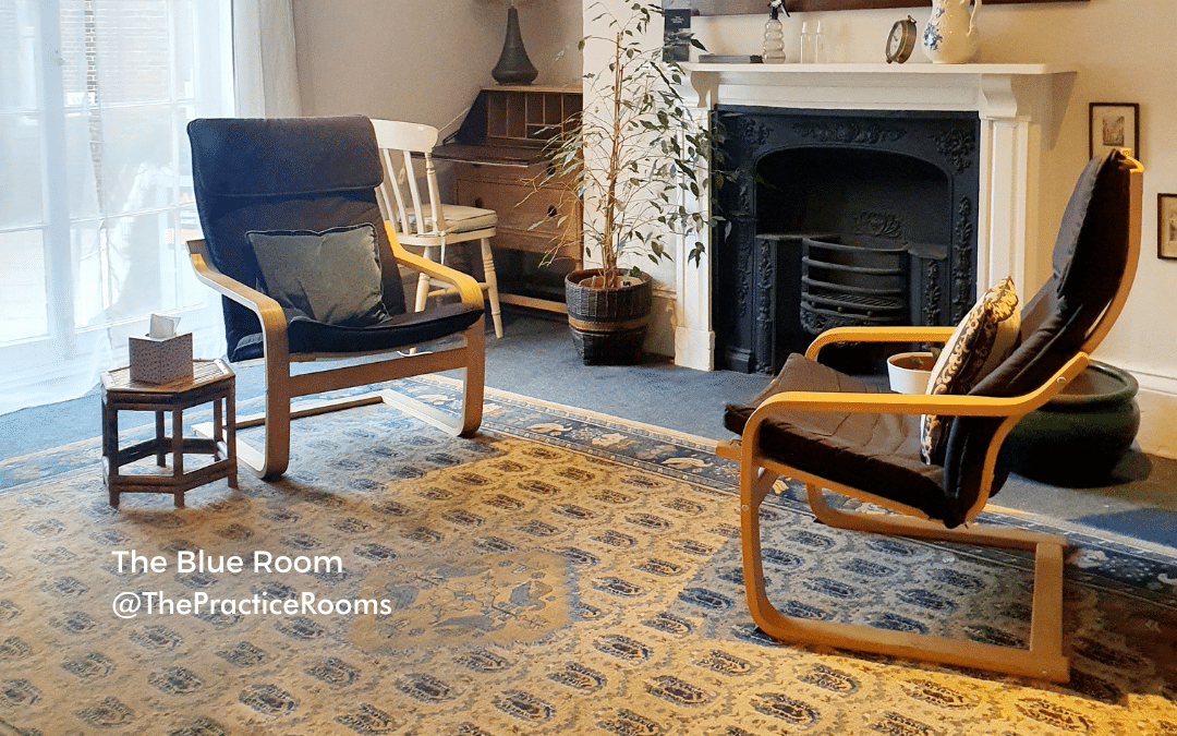 two chairs in front of a fireplace in a therapy room at The Practice Rooms Exeter